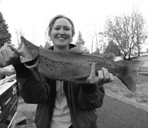 Cathy Knispel with a 2kg brown trout caught casting soft plastics around the timber.